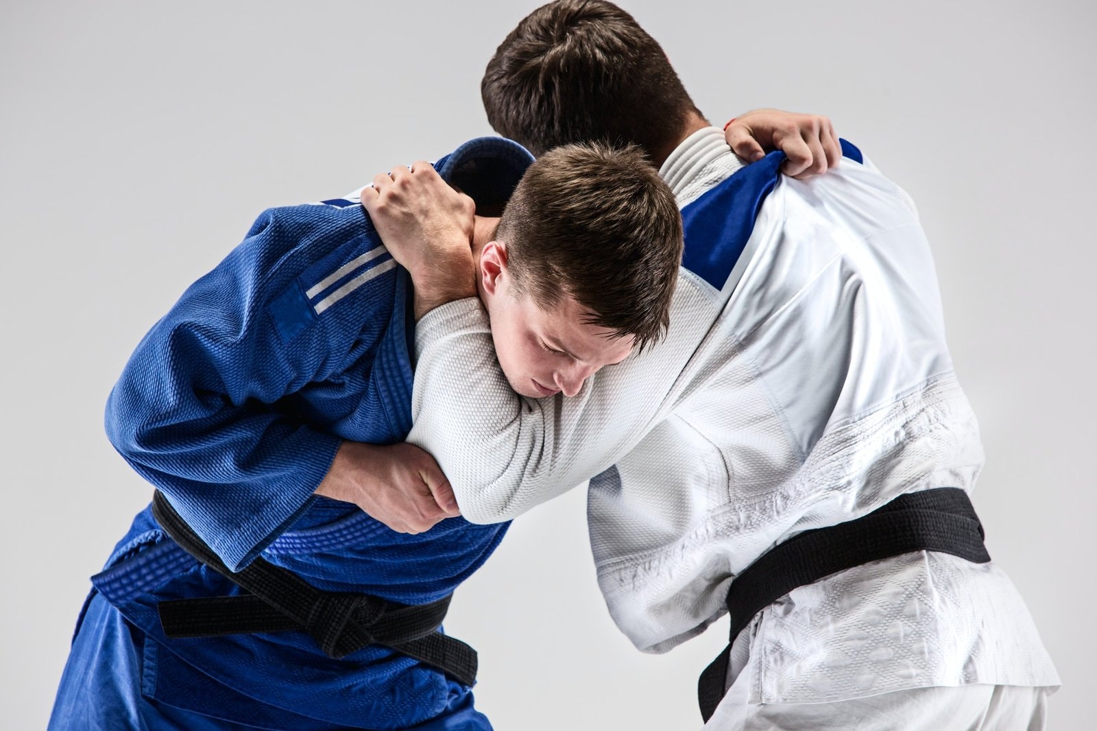 The two judokas fighters fighting men|