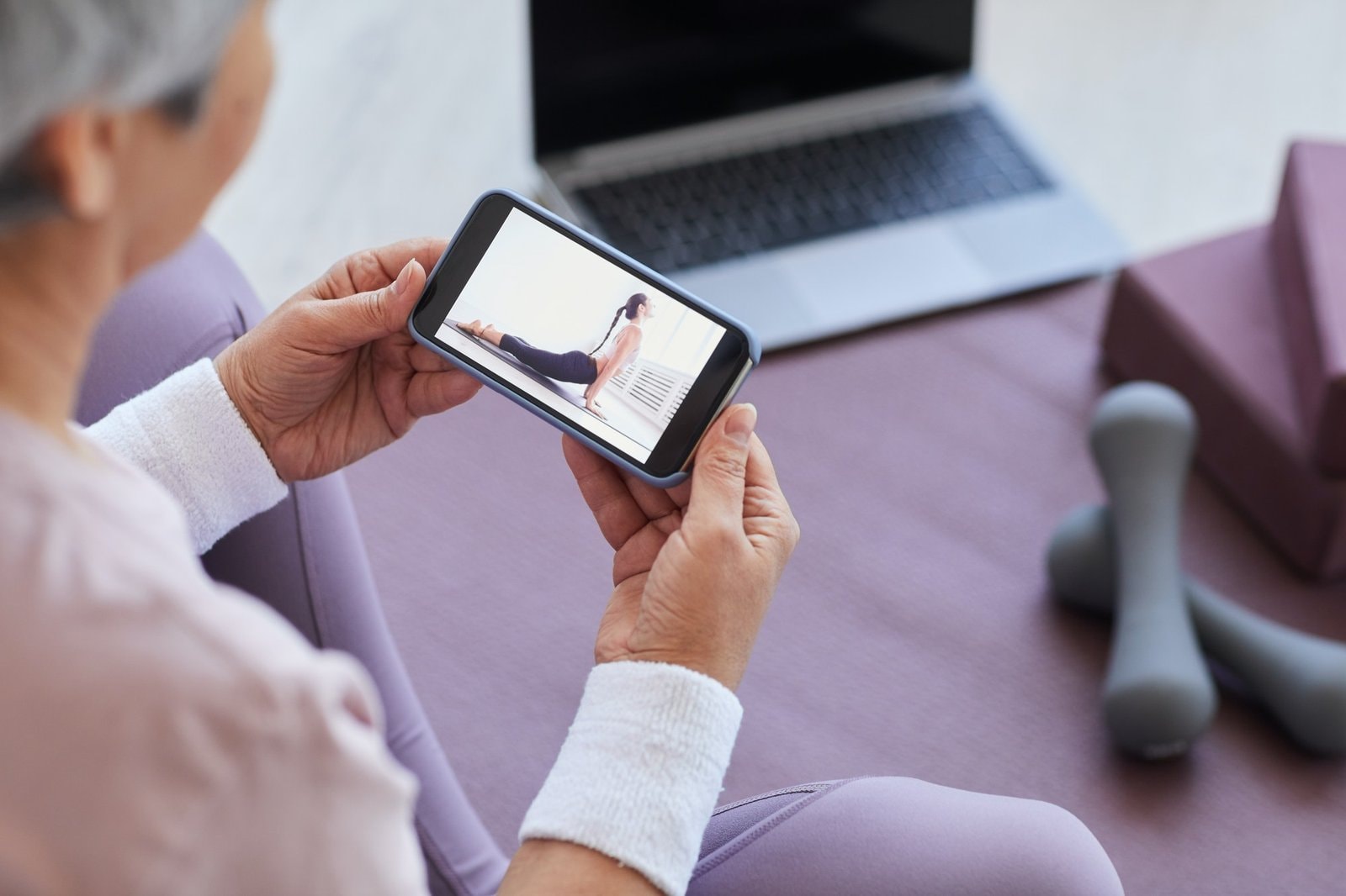 Woman looking sports exercises online|
