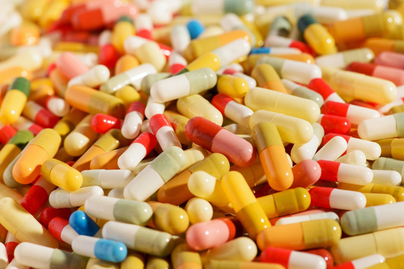 Tens of different colorful pills or capsules